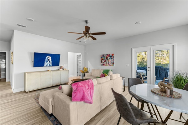 Living area with side table that is full of games and little free library