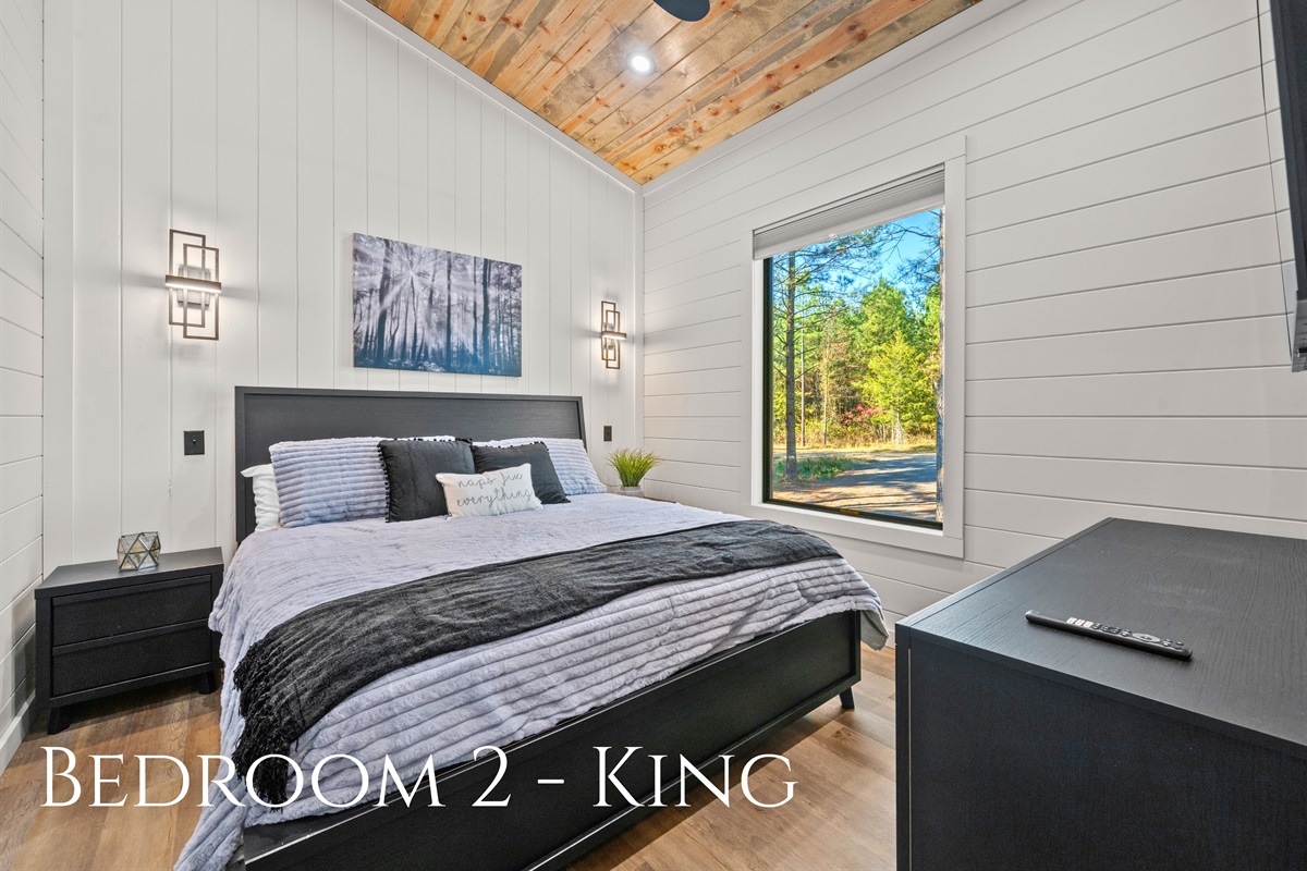 This king bedroom offers a soothing retreat with cozy bedding, soft lighting, and just the right mix of rustic charm and modern comfort.