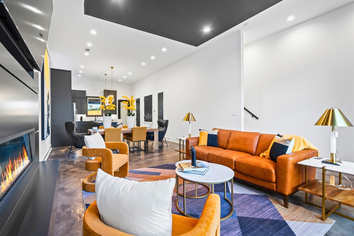 A beautifully designed living room with sleek furniture, a cozy fireplace, and bold accents, perfect for unwinding in style.