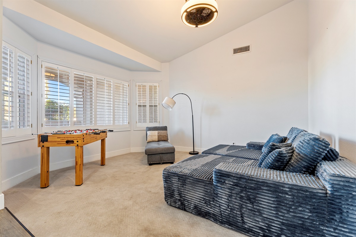 Whether you’re unwinding or playing foosball, this bonus room offers a cozy sectional, fun energy, and space to spread out.