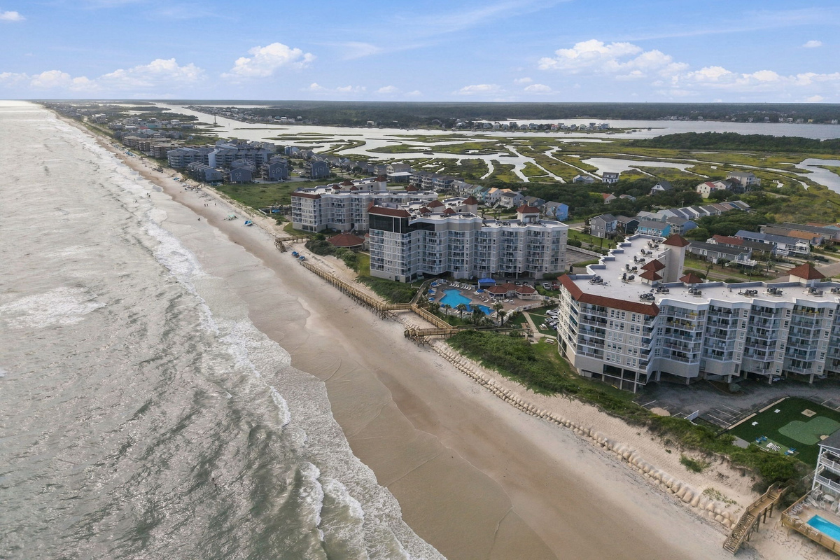 Panoramic aerial perspective of the shoreline, coastline, and nearby surrounding area.