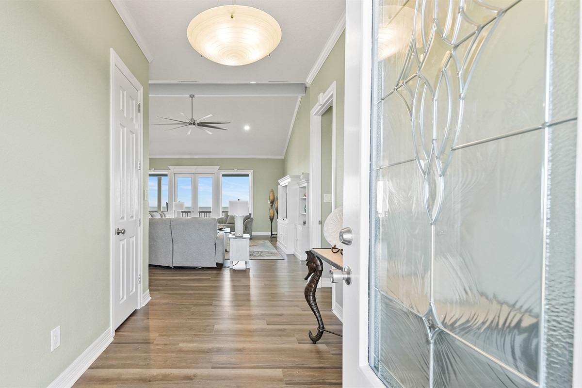 Welcome to your beachfront paradise! Step into bright, airy spaces with gleaming wood floors and coastal charm.