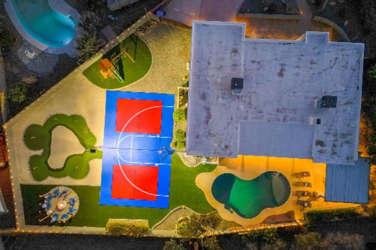 Every amenity laid out at once: pool, court, putting green, playground — a full day of options without leaving the yard.