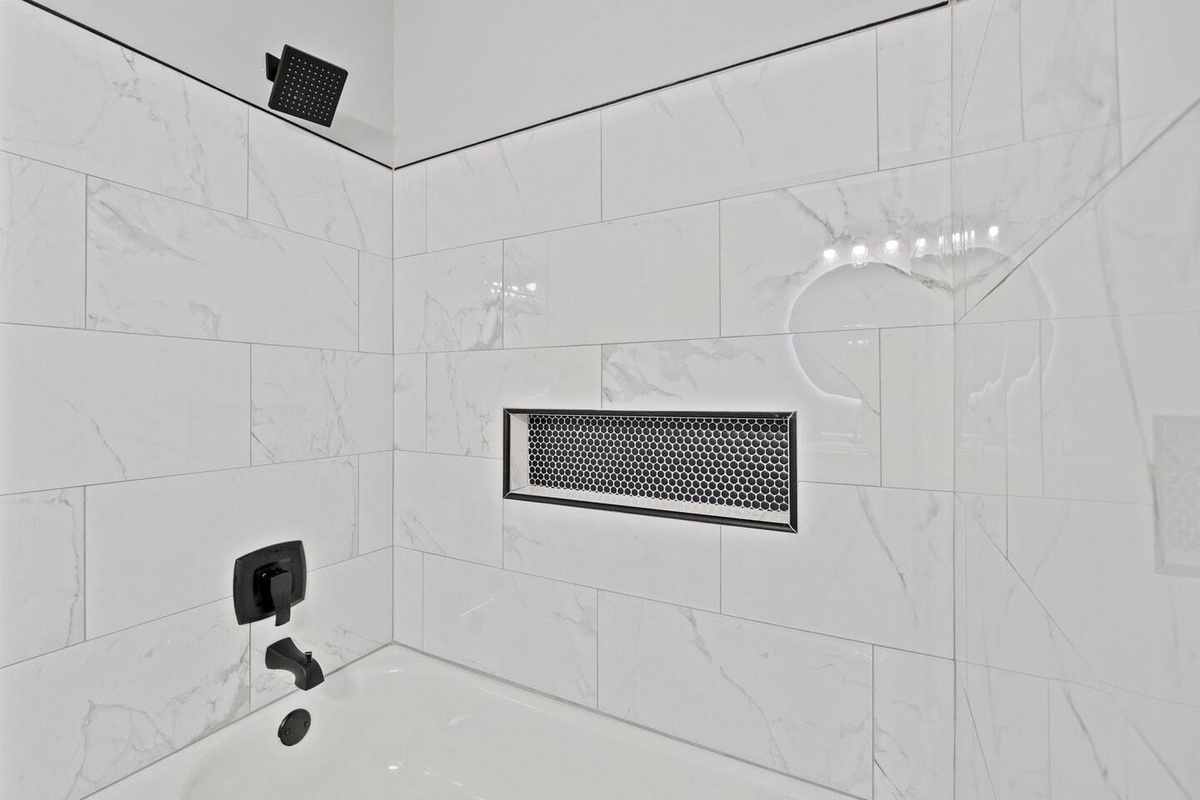Spacious full bathroom equipped with both a shower and a relaxing tub, providing the perfect space for comfort and convenience.