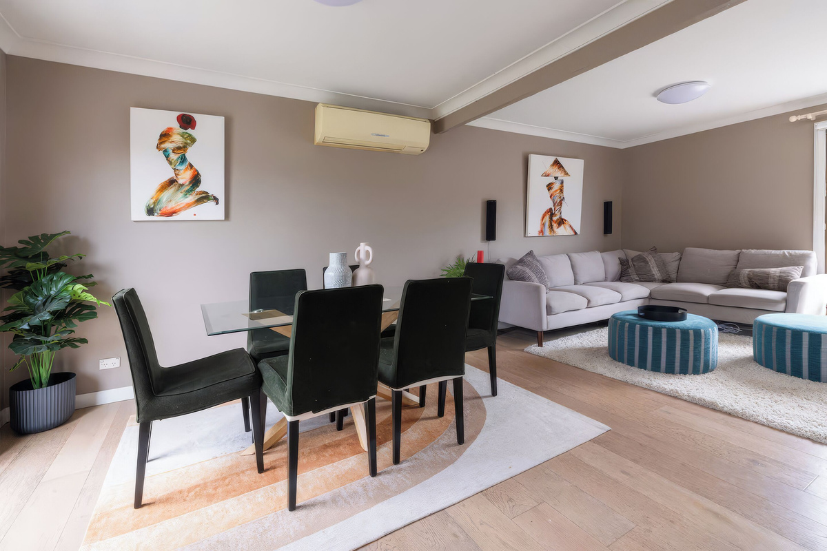 The living area upstairs at Luna’s Sanctuary includes comfortable seating, TV and easy connection to the dining and kitchen spaces.