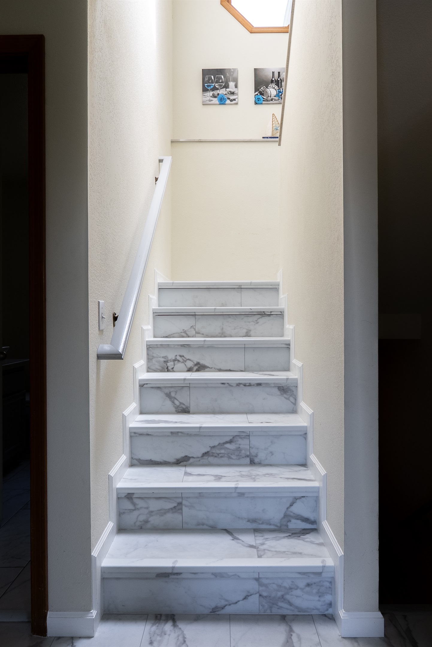 Access the home through this marble staircase with sleek trim.