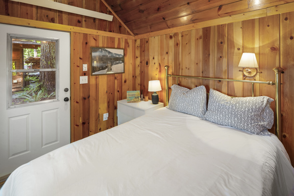 Detached cottage with a queen bed and half bath.