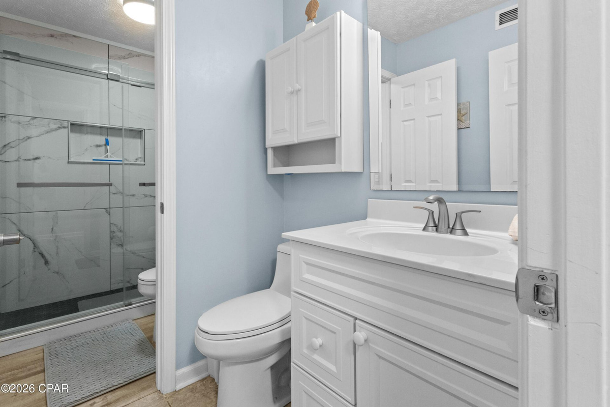 Thoughtfully designed layout with hallway half bath access to the newly tiled master shower.