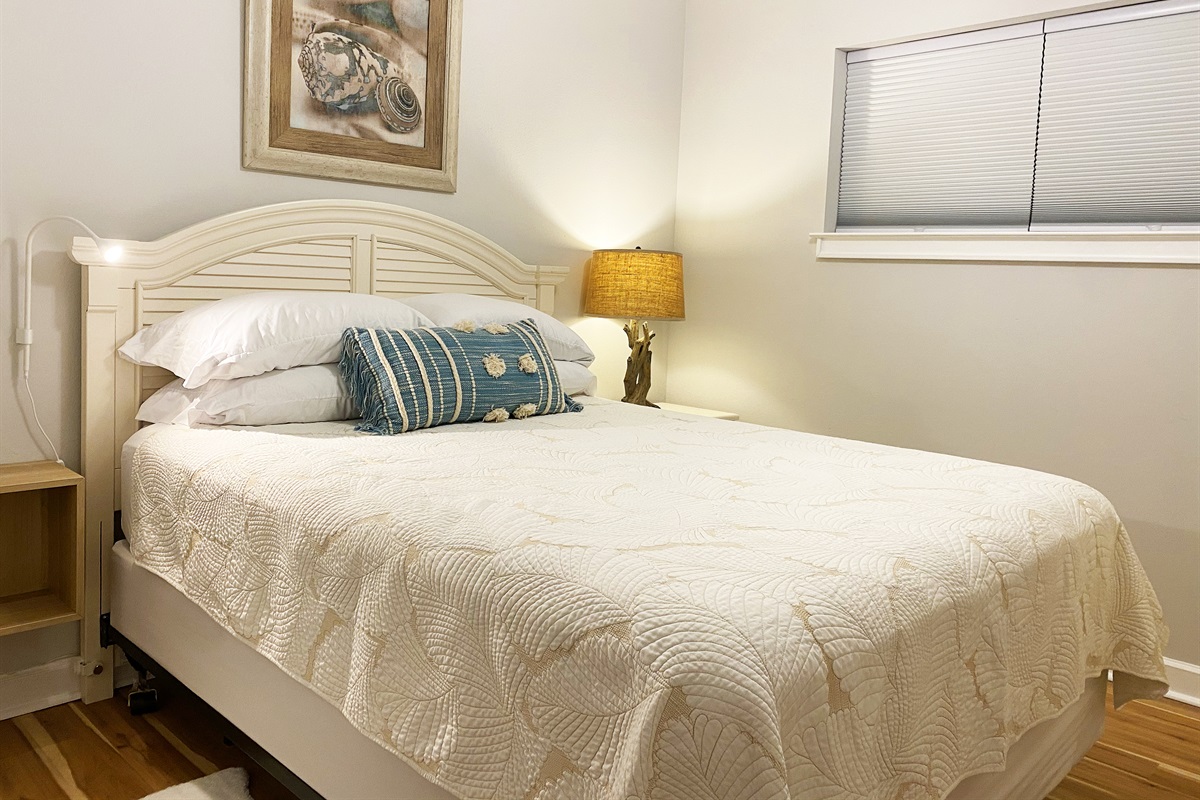 TIDELANDS | Bedroom 2: comfy queen bed with storage & lamps on both sides. Blackout blinds + ceiling fan!