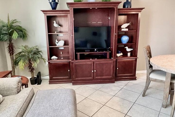 Living Room: Stylish decor and vibrant touches create the perfect space to unwind after beach days!