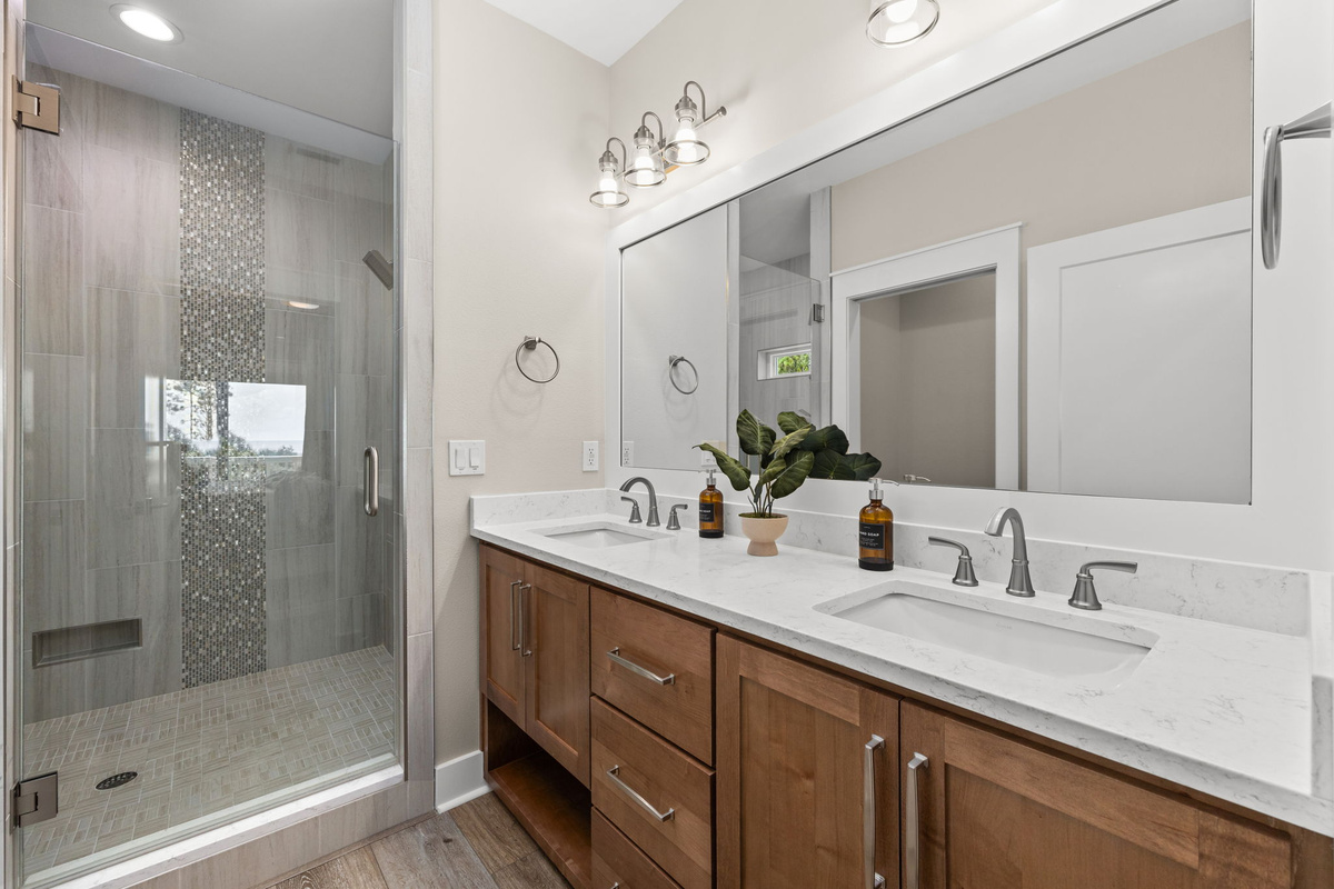The spacious en suite bathroom features a walk-in tiled shower and double vanity, giving everyone room to get ready for another day of adventure.