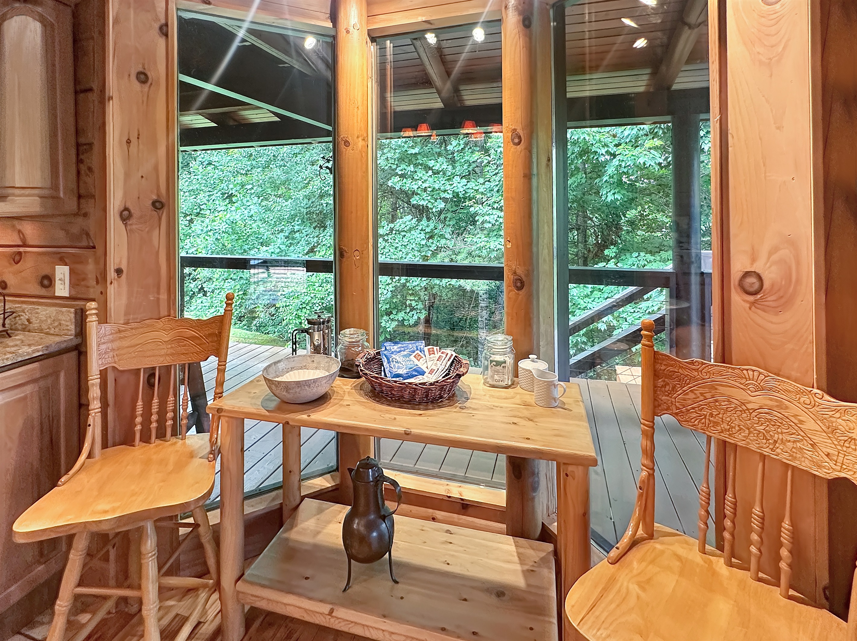 Breakfast Nook: Enjoy morning coffee amid tranquil forest views and delightful rustic charm!