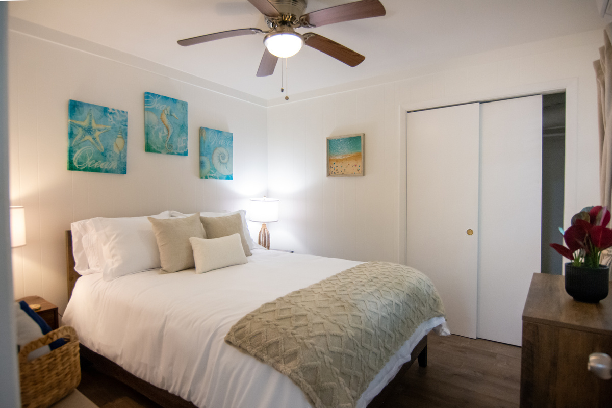 Private bedroom with queen bed, ceiling fan and closet space