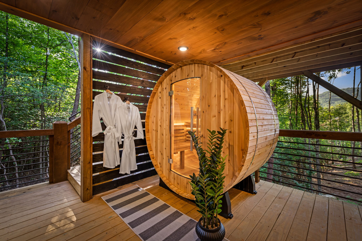 Barrell sauna with rocks and water bucket and ladle