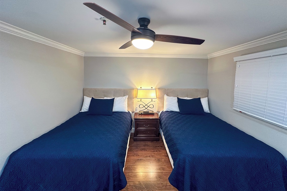 Two double beds with Beautyrest mattresses in the second bedroom.