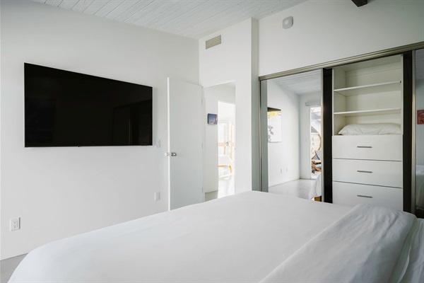 Middle bedroom with SMART TV and access to small patio 