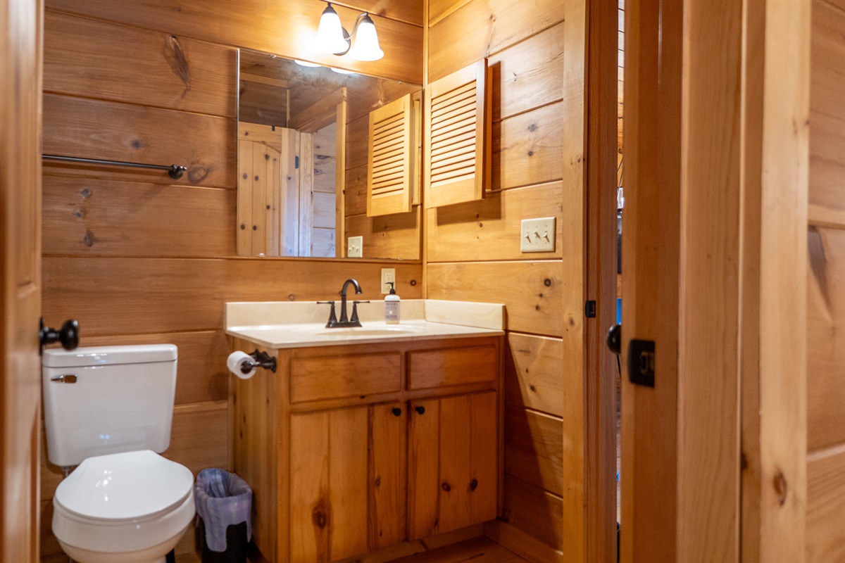 The en-suite bathroom in the main level bedroom provides privacy and modern amenities.