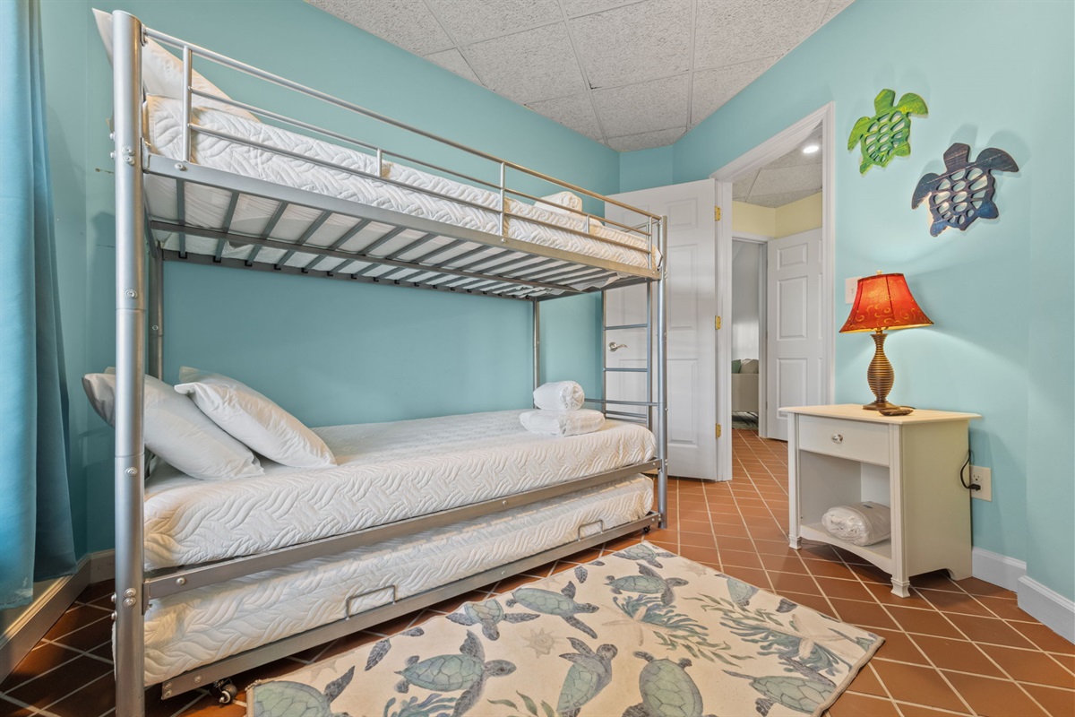 Bright Kids' room with bunk bed and pullout trundle for flexible sleeping