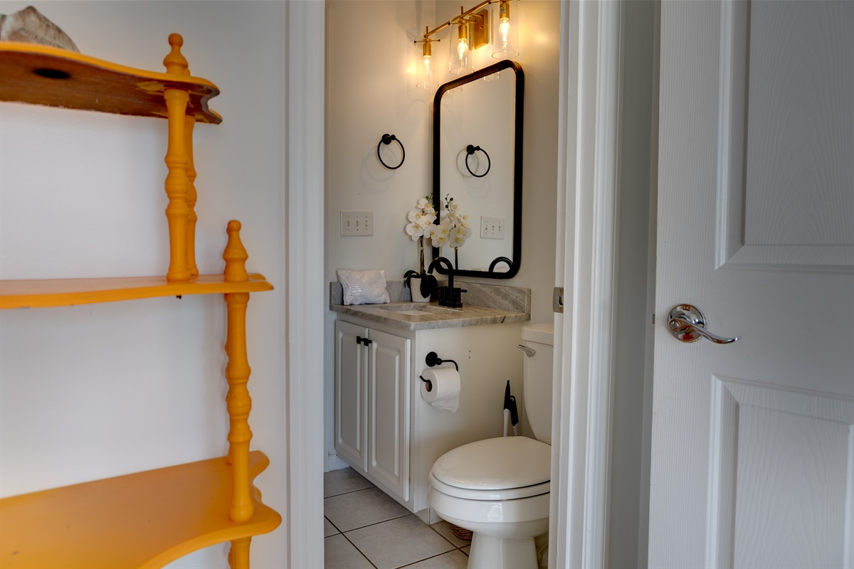 This thoughtfully designed full bathroom features a modern vanity with ample counter space