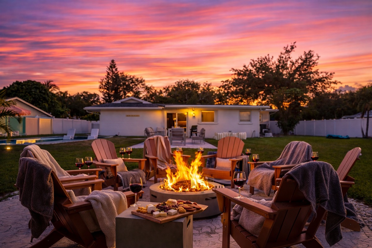 Gas-powered fire pit surrounded by Adirondack chairs in a private, family-friendly Palm Beach backyard.