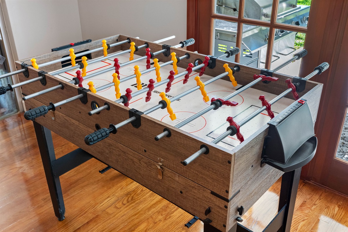 This game room features a foosball table, perfect for friendly matches and endless entertainment.