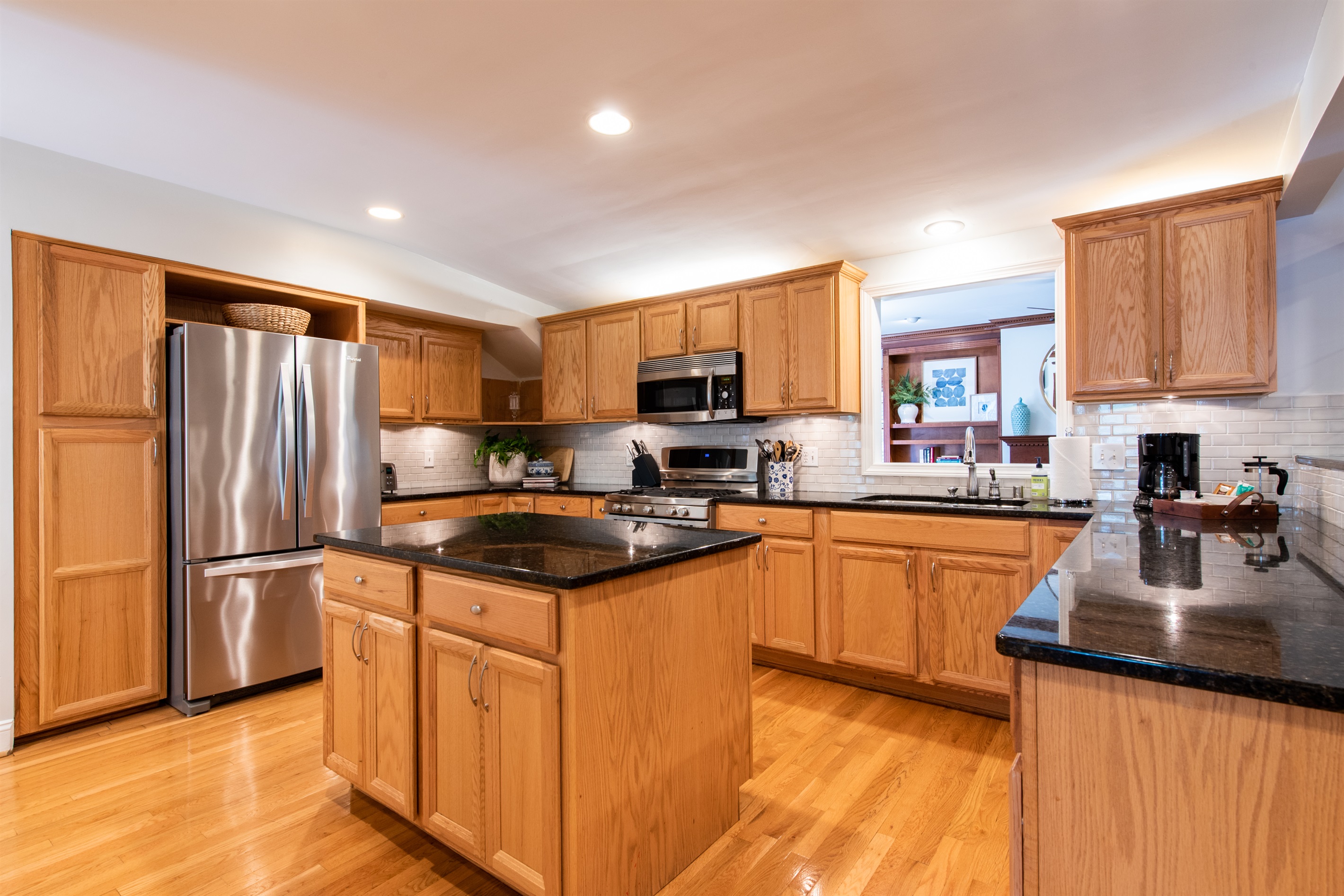Cook in style in this modern Louisville kitchen on the Kentucky Bourbon Trail. Enjoy a large island with black granite counters, stainless steel appliances, & warm hardwood floors.