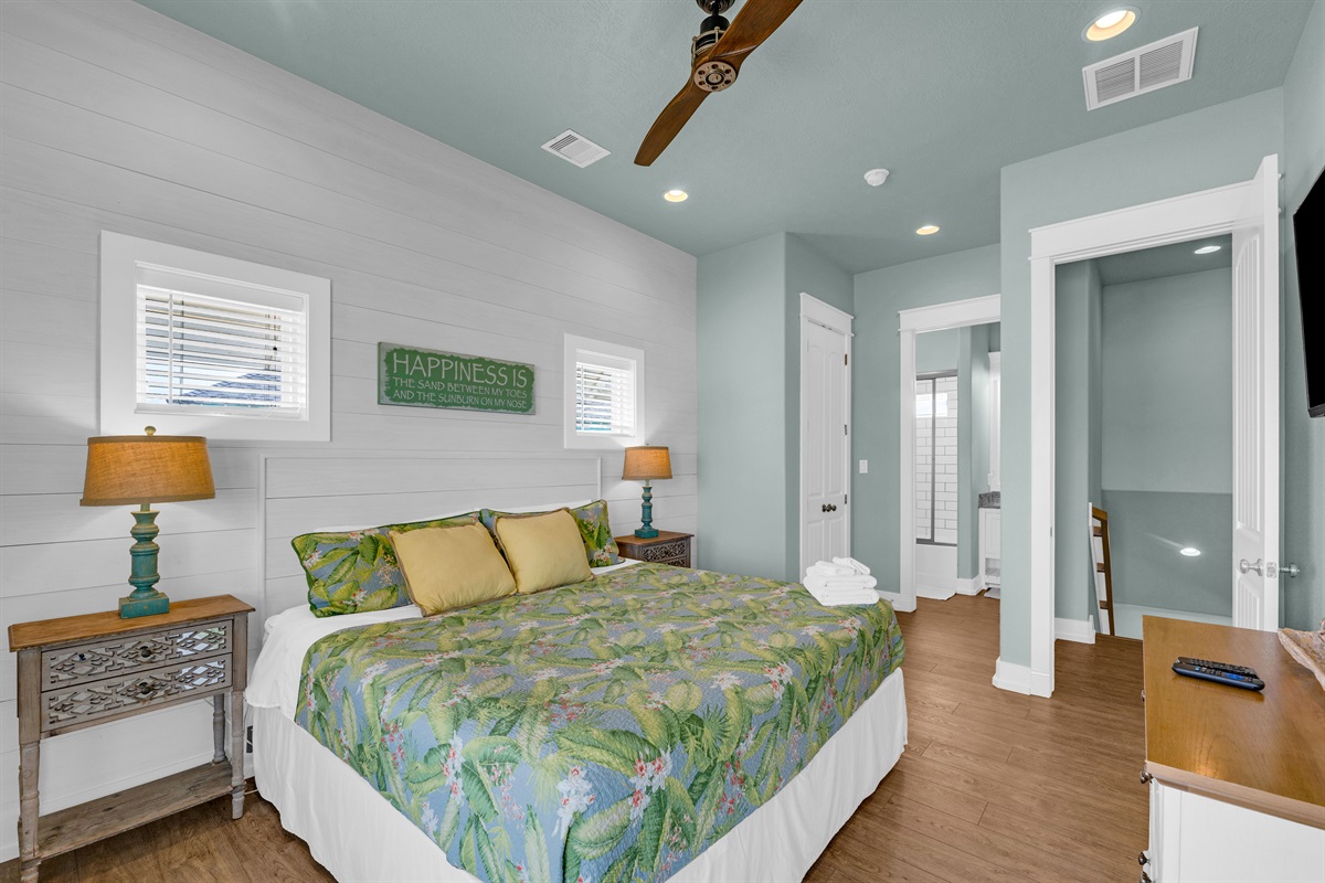 Sea It All: Primary bedroom on the second floor with private access to the upper viewing deck. 