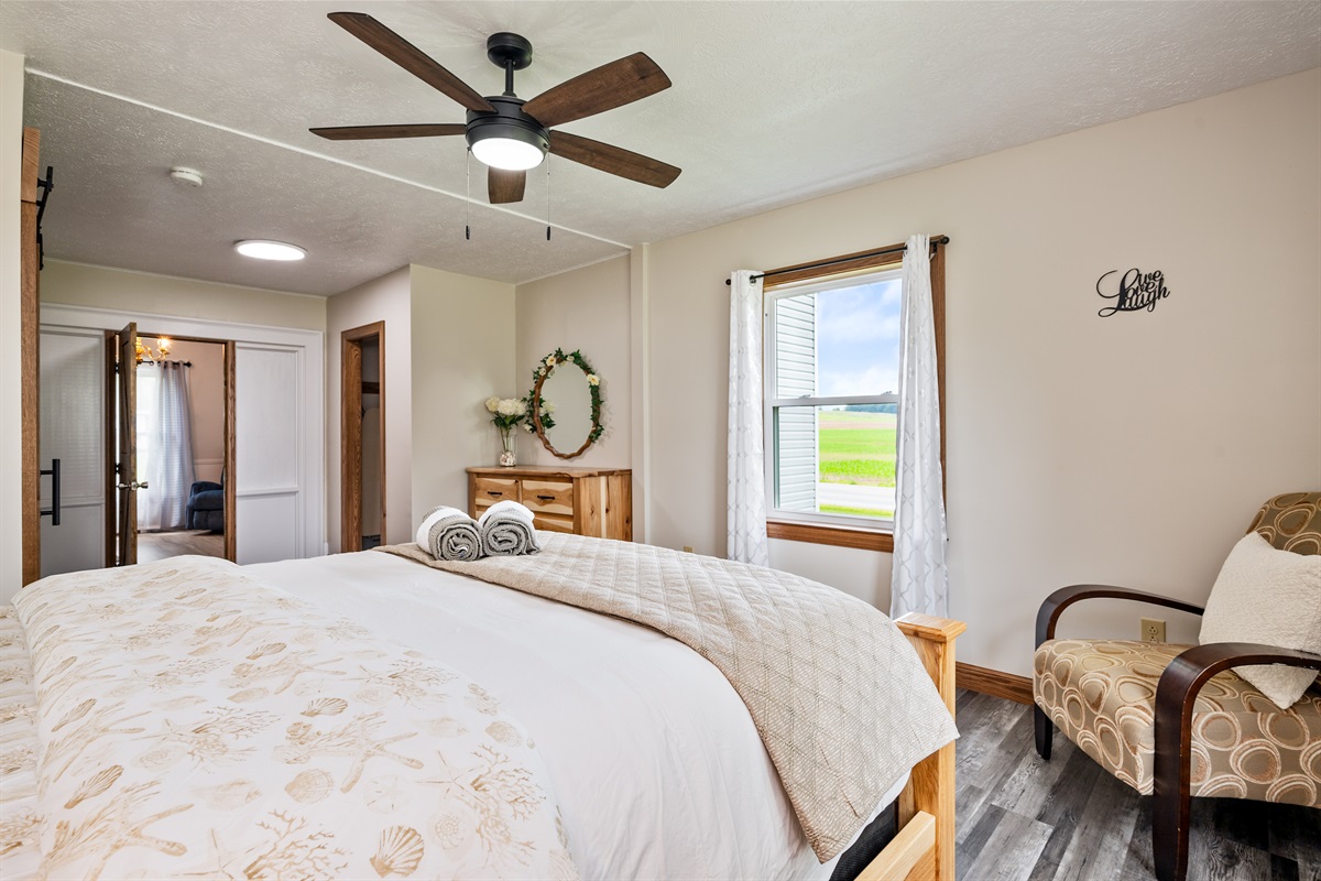 Spacious bedroom retreat with serene farmland views, fresh linens, and thoughtful decor touches.