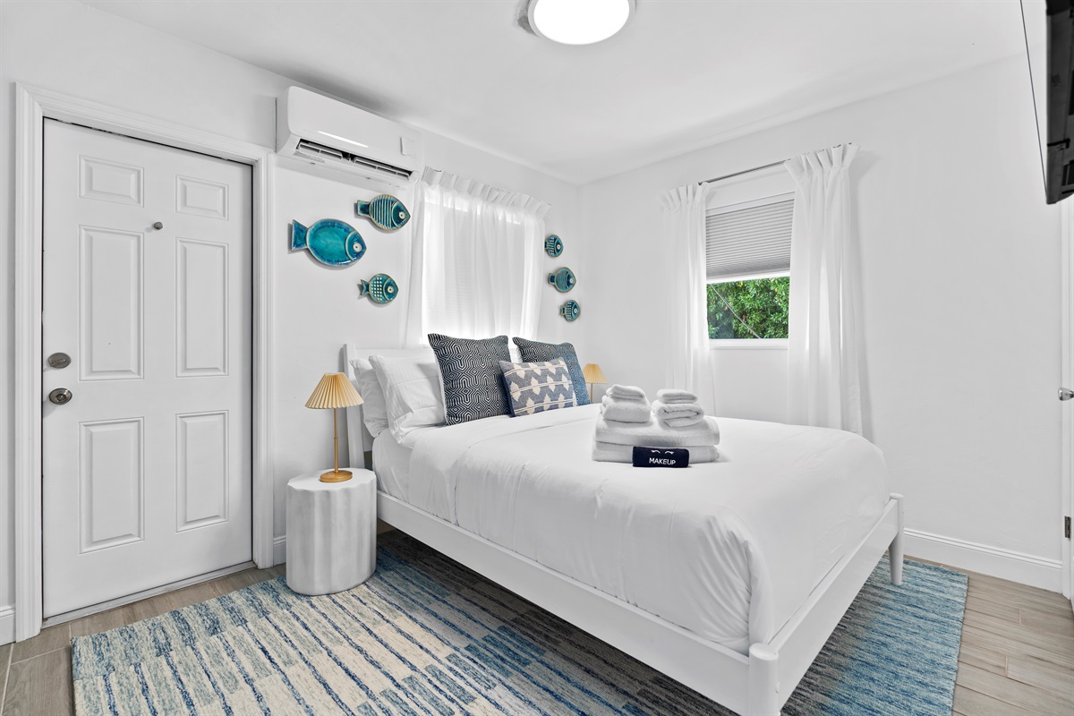 Relaxing guest bedroom with coastal-inspired decor and plush bedding.