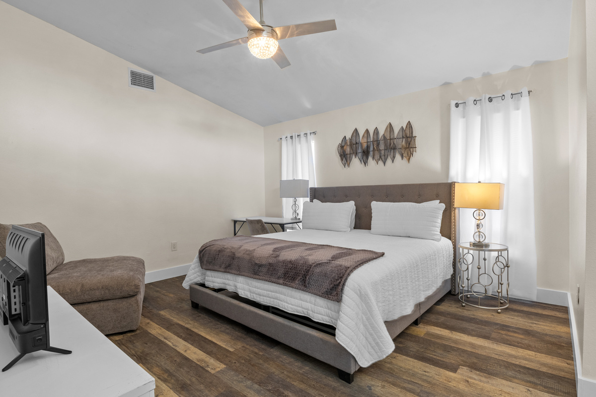 Spacious primary bedroom featuring a dedicated desk workspace.