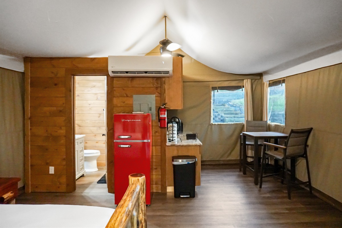 Kitchenette: Enjoy a vibrant red fridge and rustic charm for your culinary adventures!