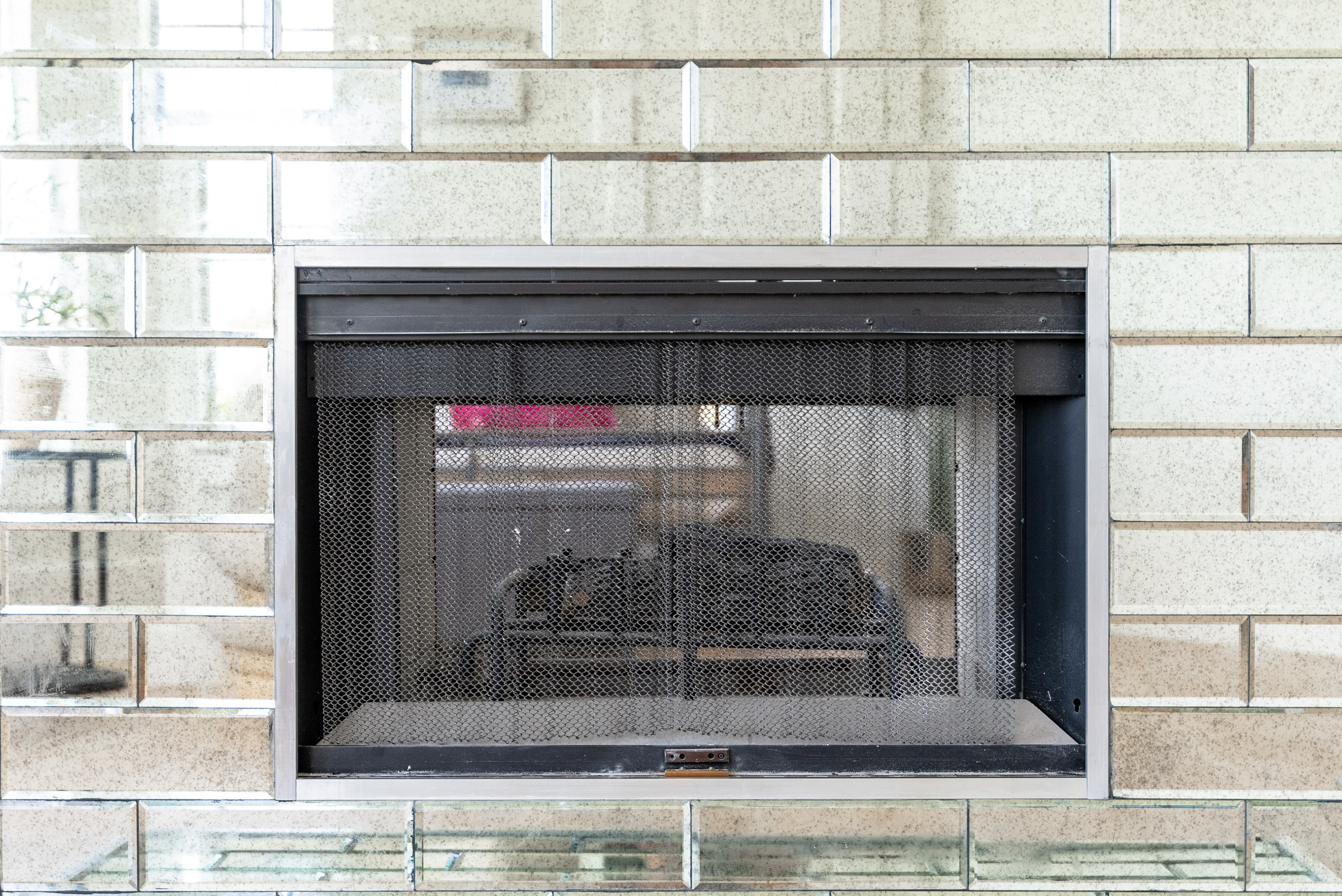 Glass-front fireplace adds warmth and ambiance to the primary suite.