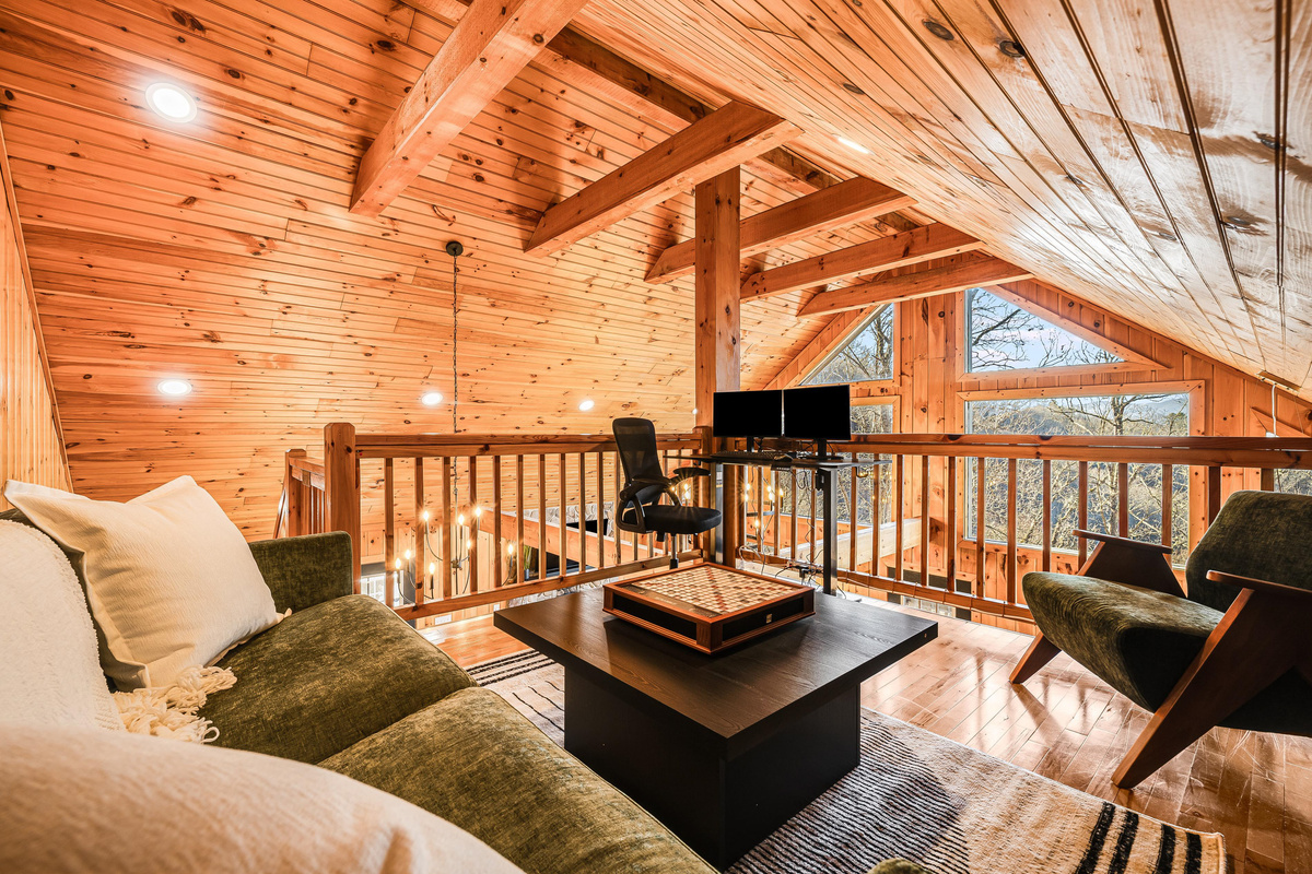 The loft area offers a versatile space perfect for unwinding with a good book, enjoying a fun board game night, or gett