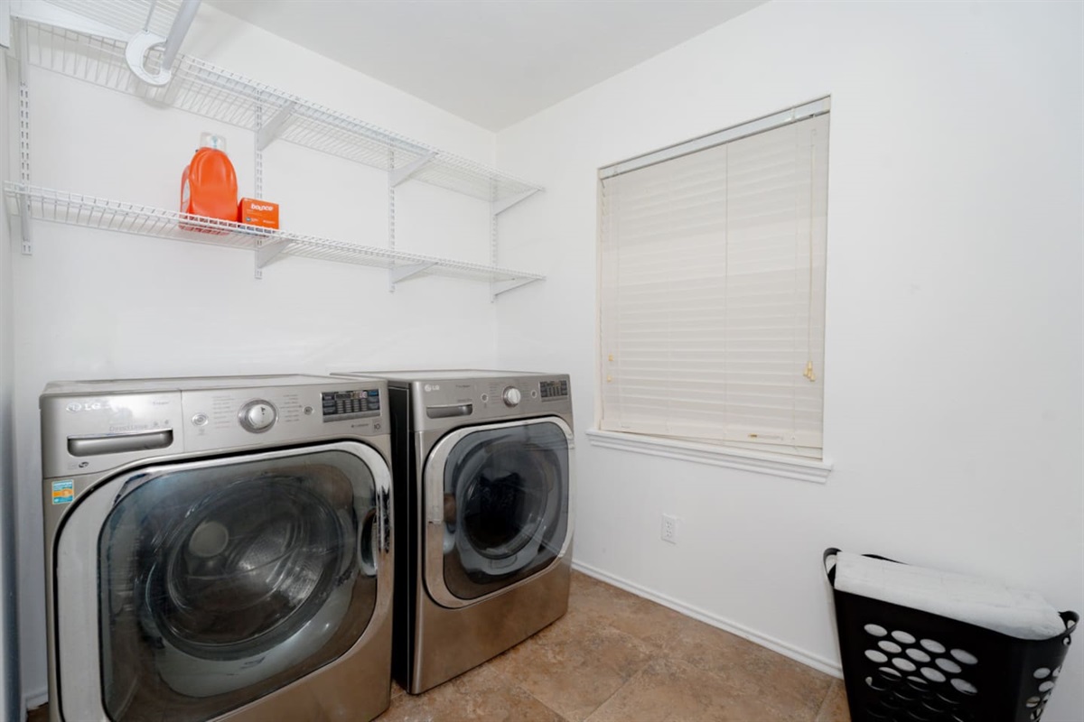 Convenient laundry room with modern washer and dryer.