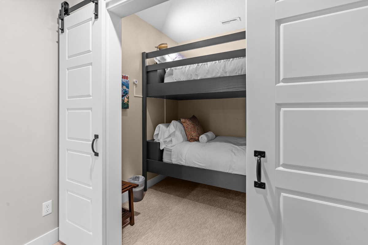 Sliding barn doors reveal a fun bunk room designed for family adventures.