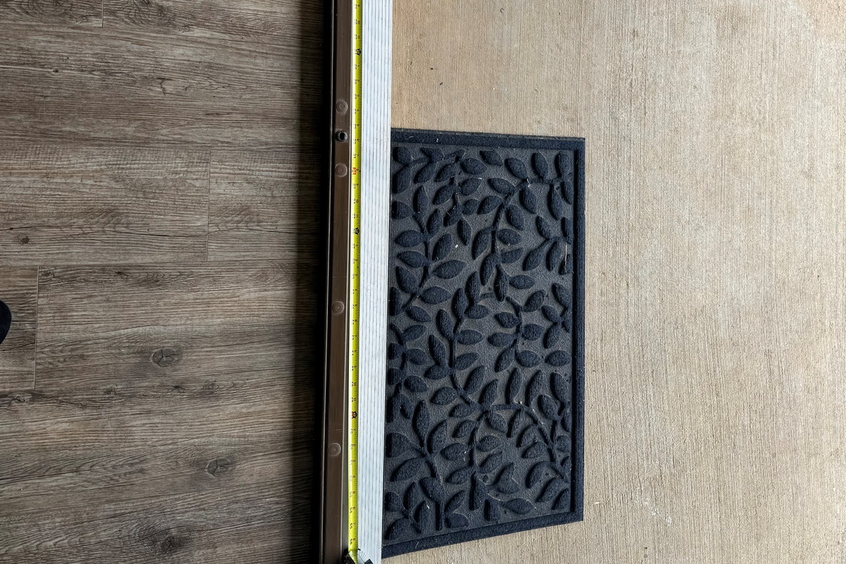 Extra wide door from the kitchen to the rear porch with small lip just under an inch and a half