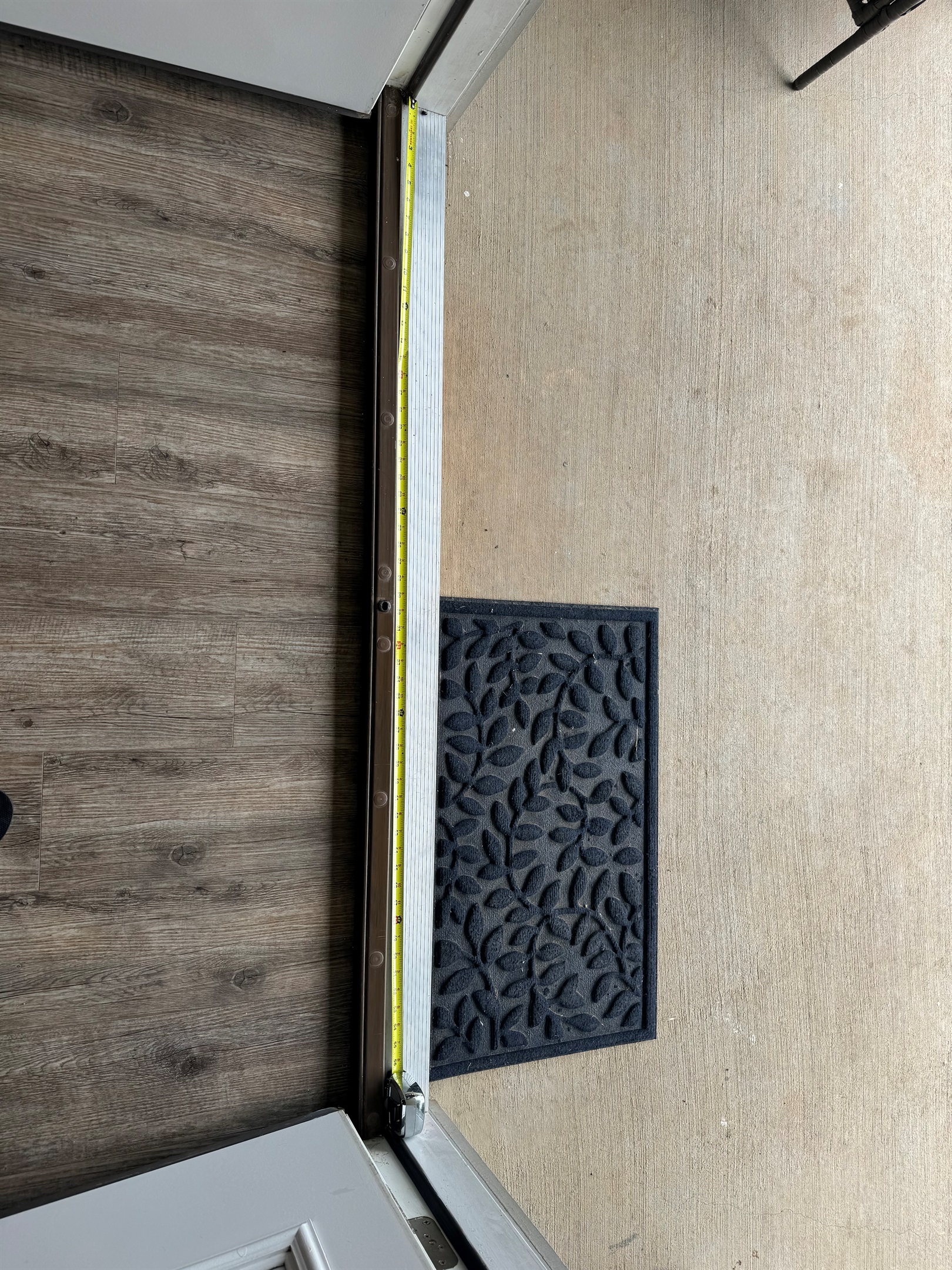 Extra wide door from the kitchen to the rear porch with small lip just under an inch and a half