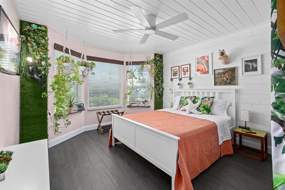 This bright, tropical bedroom has comfy bedding perfect for a good night's sleep.