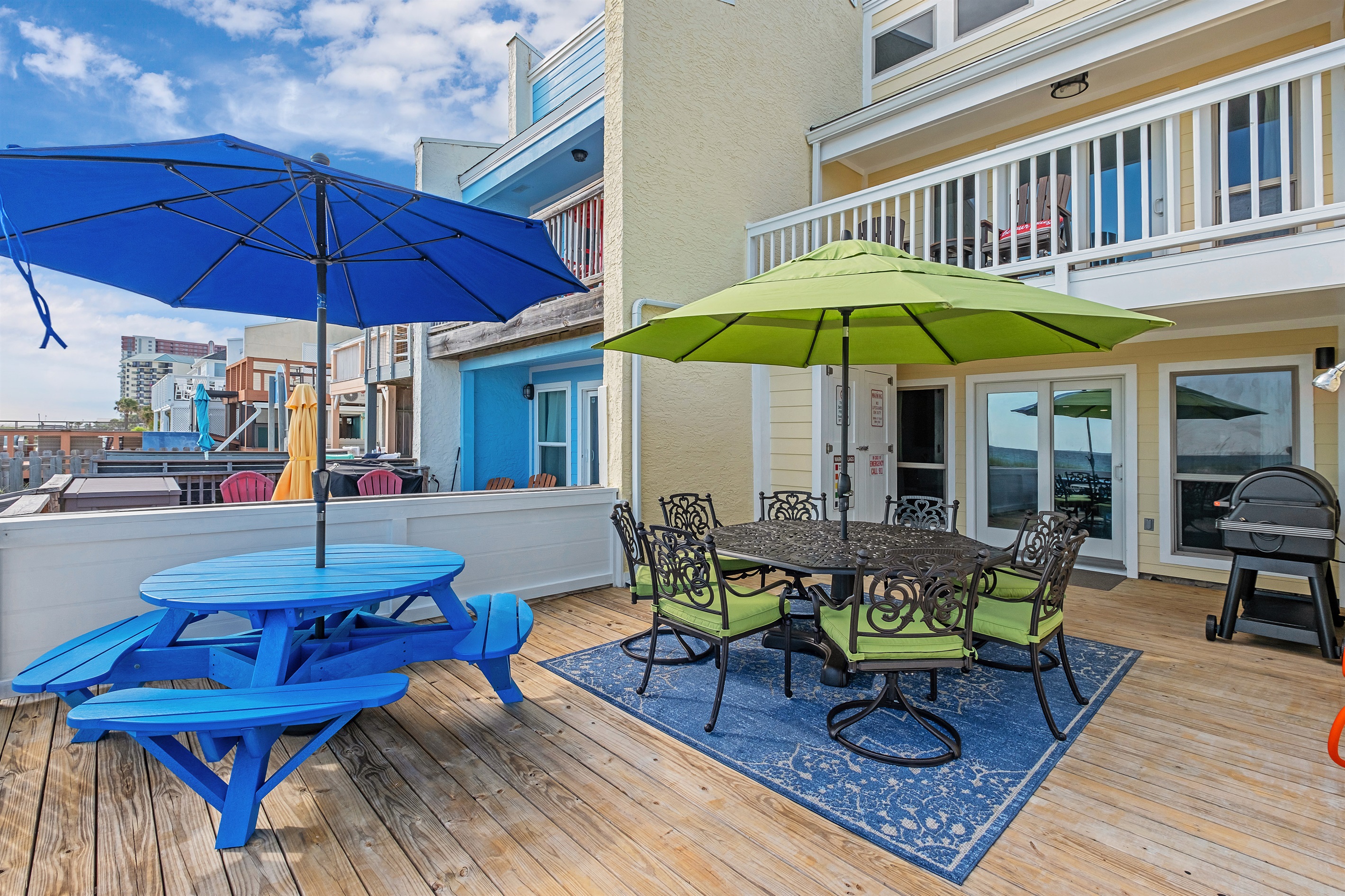 righten up your day with our colorful patio setup featuring comfortable seating and vibrant umbrellas. Perfect for lounging, dining, and enjoying the beachfront breeze.