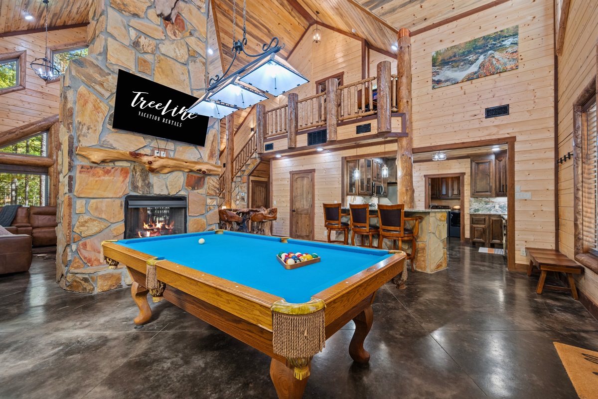 Game area with pool table and fun cabin décor.