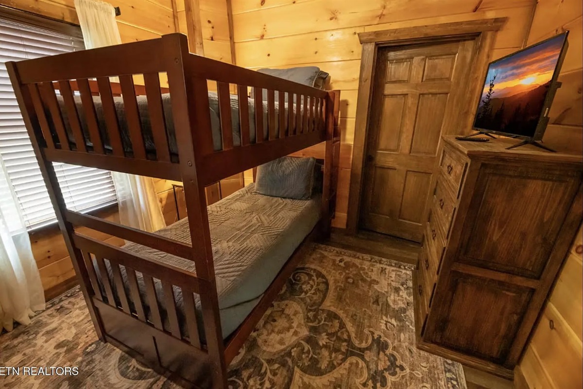 The kids will love the twin bunk bed bedroom at Marigold Cabin in Pigeon Forge, TN &mdash; a fun, cozy space designed with younger guests in mind. Perfect for family vacations to the Smoky Mountains, this dedicated kids' bedroom makes Marigold great
