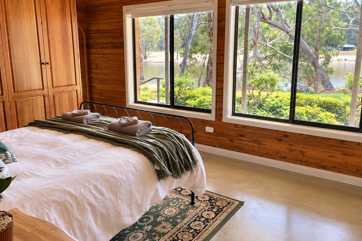 The second queen bedroom helps Bob’s River House work for larger groups, adding another main-house sleep space close to the shared areas.