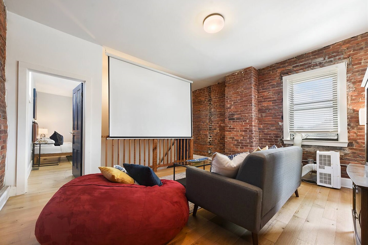 Relax in front of the theater screen on a comfy bean bag or couch.