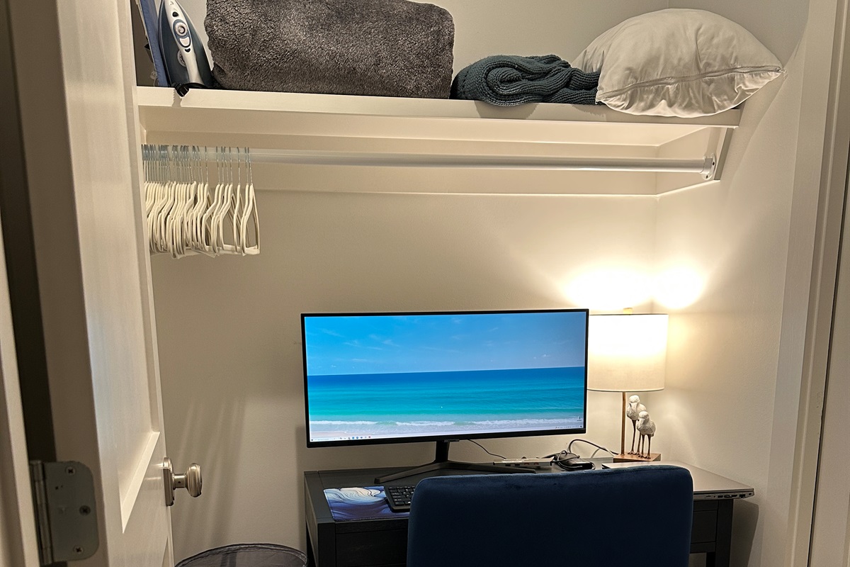 Dedicated Workspace - Tucked off the first-floor king suite, this private workspace features a small window, door, desk, comfortable chair, large monitor, docking station, keyboard, and a mouse—ideal for remote work while enjoying your beach getaway.