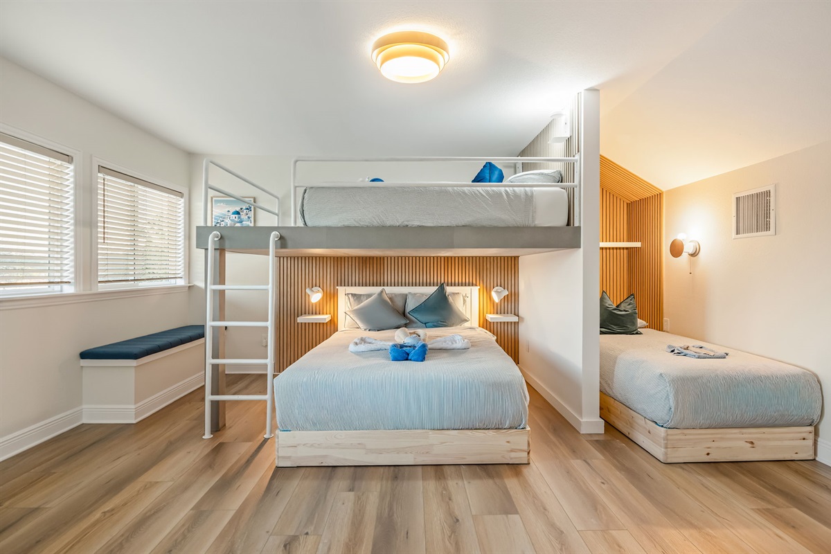 Bright family bunk room with queen bed and additional sleeping space for kids or friends.