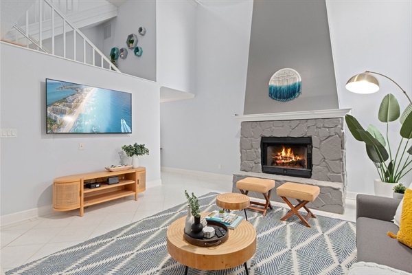 Grand living room sporting a 65" Roku TV. There's plenty of seating for the whole family to gather around and watch a movie together