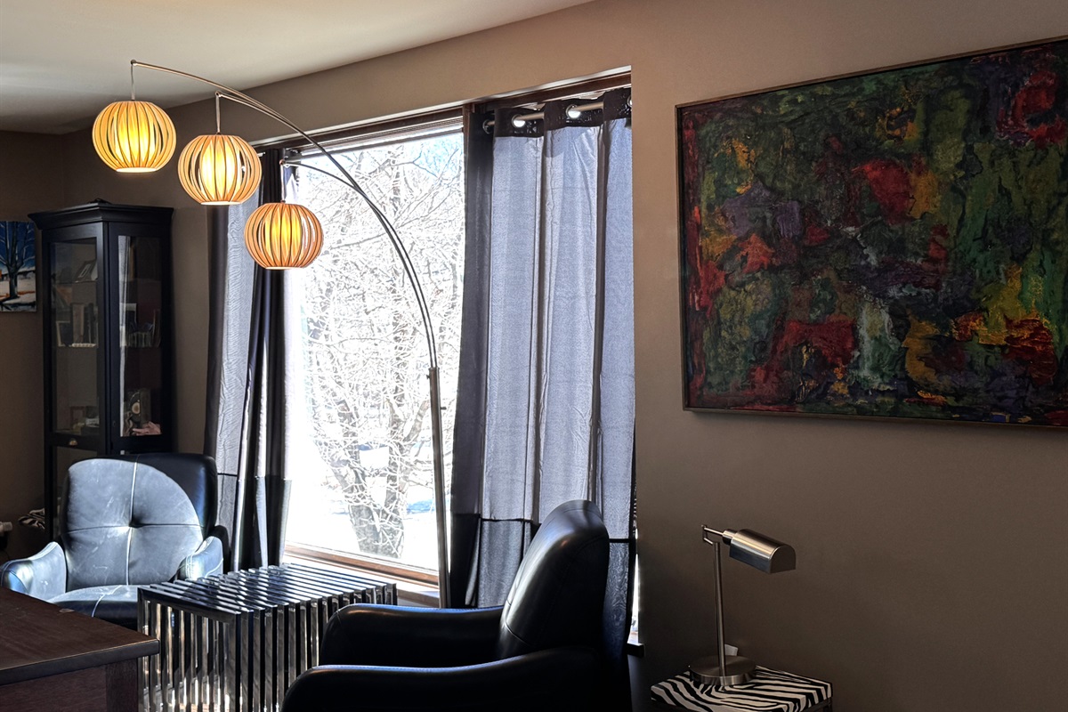 A second sun-filled sitting area on the main floor, featuring modern lounge seating and designer lighting. This quiet nook offers peaceful views of historic Otter Creek village, providing the perfect space for morning reading or private conversation.