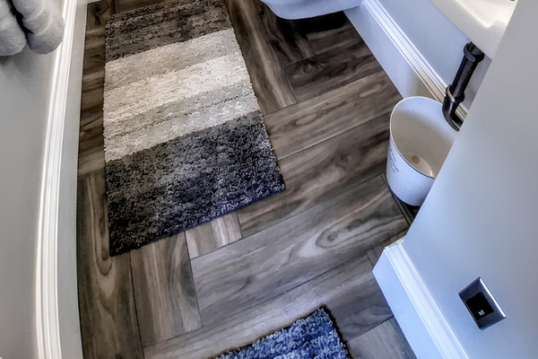 “Hirs” half bathroom offers sink, commode and towels