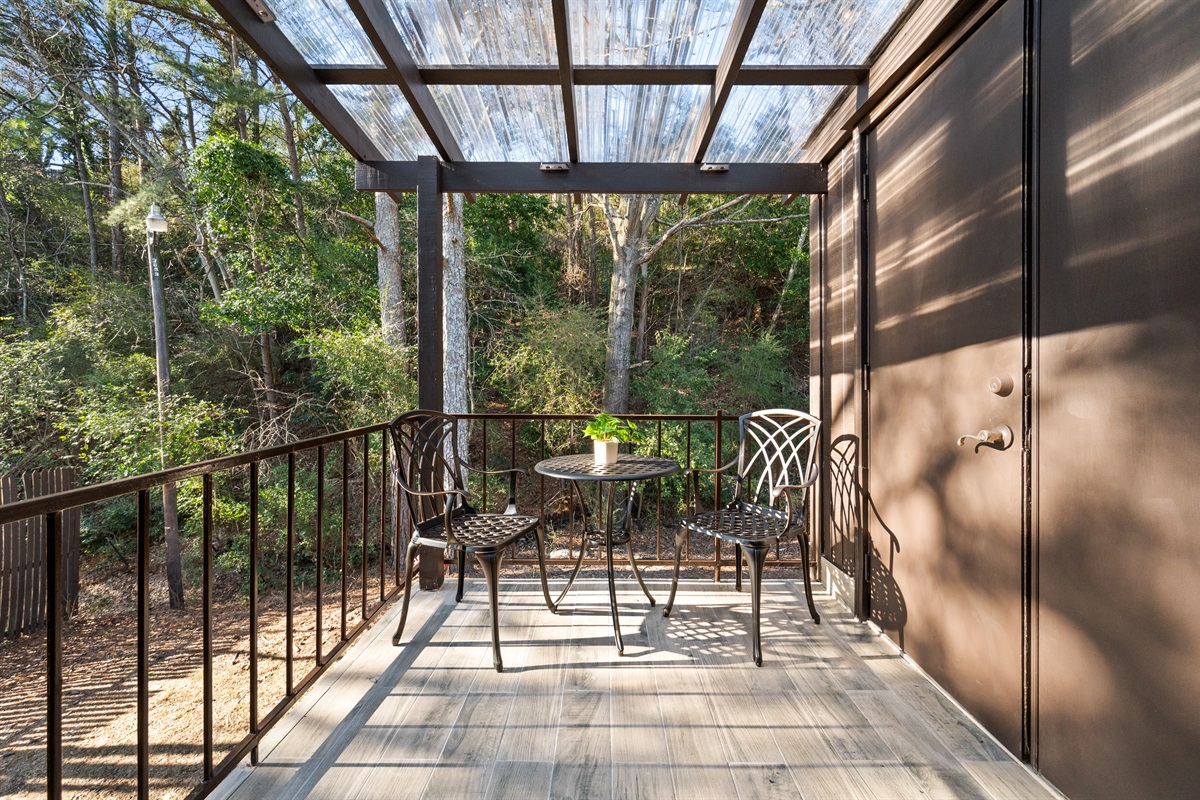 Your patio is complete with this cozy corner to enjoy coffee in the mornings. Notice the door to the right is the entrance to the laundry room.
