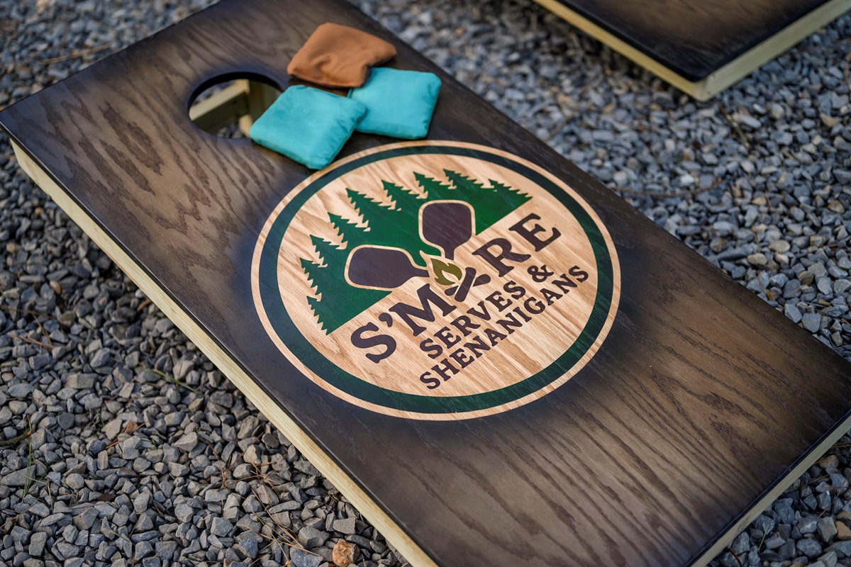 Custom cornhole boards for outdoor fun under the string lights.